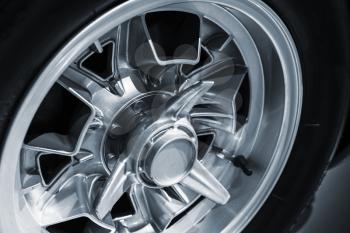 Chromed wheel disc. Luxury vintage car fragment, close up photo with selective soft focus
