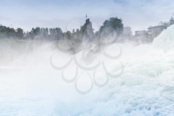 The Rhine Falls landscape. Fast fallen river water with foam and mist