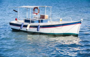 White wooden fishing boat anchored in port of Zakynthos, Greek island in the Ionian Sea
