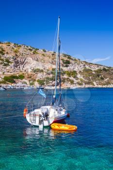 Sailing yacht moored in Agios Nikolaos bay. Zakynthos island, Greece. Popular touristic destination. Vertical photo