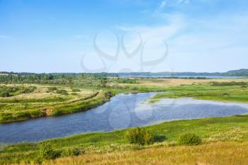 Empty rural Russian landscape. Sorot river under blue cloudy sky in the summer day