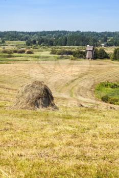 Rural Russian summer landscape with a stack of hay. Mikhaylovskoye, Pushkinogorsky District of Pskov Oblast, Russia