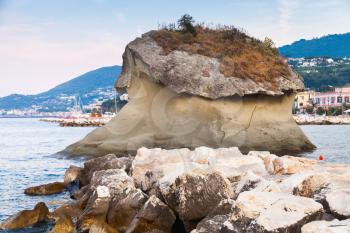 Famous coastal mushroom shaped rock Il Fungo. Lacco Ameno resort town, Ischia island, Italy
