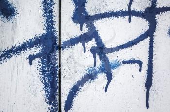Abstract dark blue graffiti fragment over old white wall