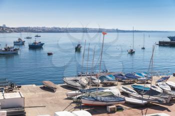 Bay of Cascais. Small sailing boats lay on the pier in summer day. Cascais municipality, Portugal