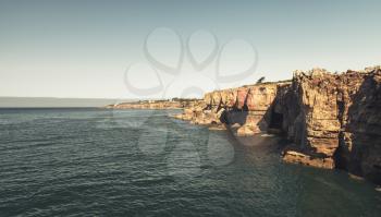 Boca do Inferno. Hell's Mouth chasm located in seaside cliffs. Natural landmark of Cascais city in the District of Lisbon, Portugal. Vintage toned photo, retro filter effect