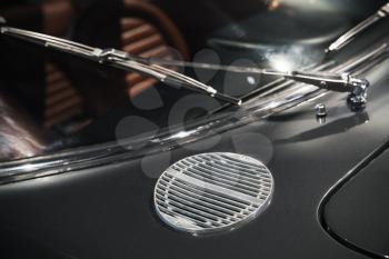 Air intake grille and windscreen wiper. Luxury vintage car fragment, close-up photo with selective soft focus