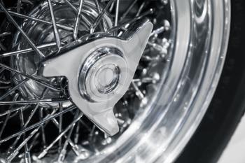 Chromed wheel disc. Luxury Italian vintage sport car fragment, close up photo with selective soft focus