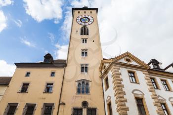 Regensburg clock tower facade under cloudy sky, Germany. The Oldest Town on the Danube River
