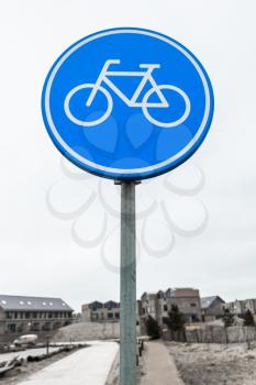 Bicycle lane, round blue road sign. Amsterdam, Netherlands