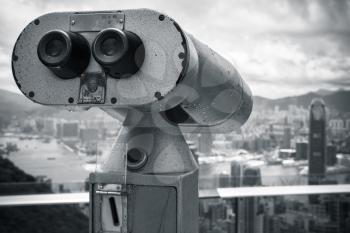 Monochrome photo of tourist binocular telescope for Hong Kong city observation from Victoria Peak viewpoint