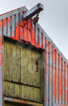 Norwegian fishing hangar with rusted manual crane hook