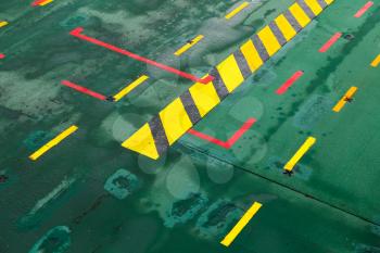 Green ferry deck with colorful marking, shipping transportation background photo