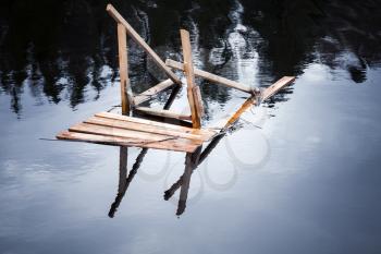 Broken wooden gangway to the river