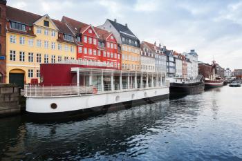 Old ships moored in Nyhavn, 17th-century waterfront, canal and popular touristic district in Copenhagen, Denmark