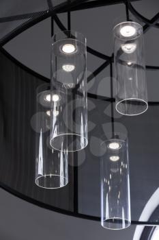 Modern interior design, vertical fragment, chandelier with round glass lampshades and white LED lights