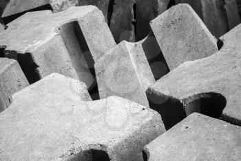 Rough gray concrete blocks as a part of breakwater structure for protection from ocean stormy waves 