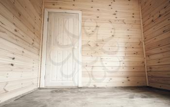 White door in empty room, wooden house interior background