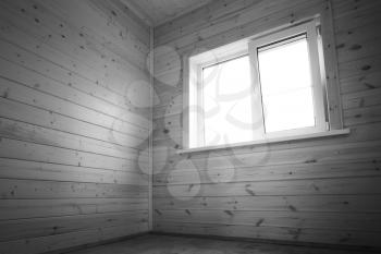 White window in empty room, wooden interior background. Black and white photo