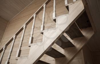 Balusters of stairway railings. Empty wooden house interior