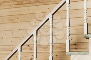 White balusters, stairway railings. Empty wooden house interior