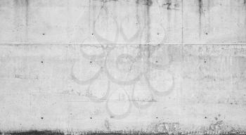 Gray concrete wall with dark wet stains, frontal background photo texture