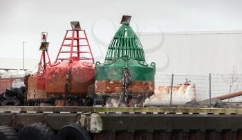 Old navigation buoys stand on the pier in port of Reykjavik, Iceland