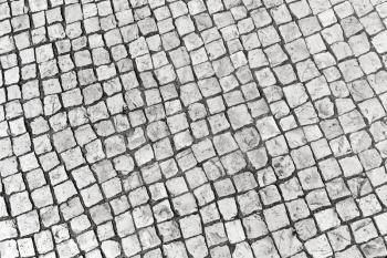 Typical portuguese cobblestone handmade pavement of white square fragments. Lisbon, Portugal
