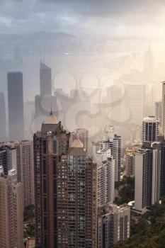 Modern skyline of Hong Kong city, aerial view taken from Victoria Peak viewpoint in foggy day