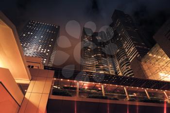 Modern city at night. Dark skyscrapers, high-rise corporate buildings of Hong Kong