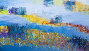 Rippled water surface with bright reflections, abstract background photo texture