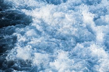 Blue ocean water with splashes and foam, natural background photo texture