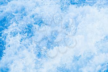 Blue sea water with splashes and foam, natural background photo texture