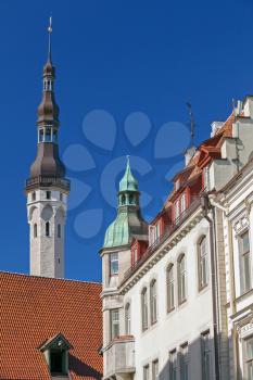 Street fragment with tall town hall tower. Old Tallinn, Estonia