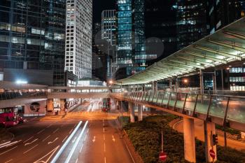 Modern night cityscape, blurred car lights on the street of Hong Kong city