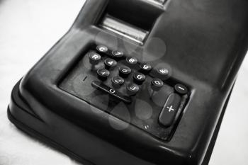 Vintage mechanical calculator, closeup photo with selective soft focus