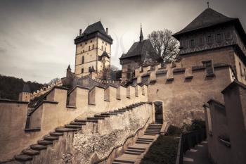 Karlstejn castle exterior. Gothic castle founded 1348 CE by Charles IV, Holy Roman Emperor-elect and King of Bohemia. Located in Karlstejn village, Czech Republic. Vintage toned photo