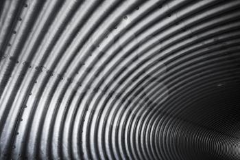 Corrugated metal tunnel, abstract industrial background texture