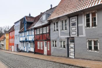 Narrow street with colorful houses in old town of Flensburg, Germany