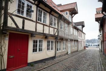 Narrow street with traditional colorful living houses in old town Flensburg, Germany