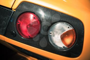Rear lights on a luxury yellow sports car, close up-photo 