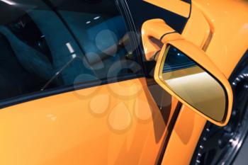 Luxury yellow sports car mirror, closeup photo