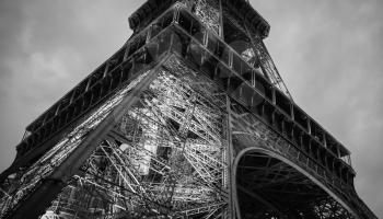 Fragment of Eiffel Tower, low level, the most popular landmark of Paris, France. Black and white photo