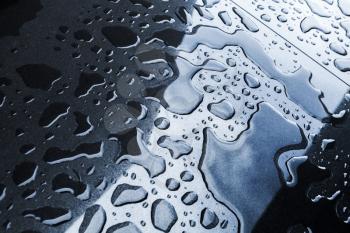 Wet shiny black stone surface with water droplets, background photo