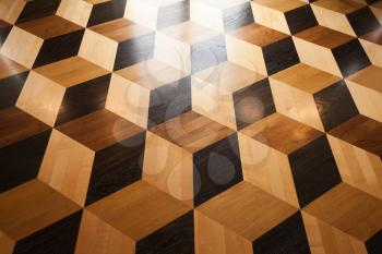 Shining wooden parquet flooring design with volume cubes illusion. Background photo