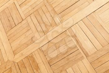 Parquet made of oak wood planks with square geometric pattern, decorative tiling. Background texture