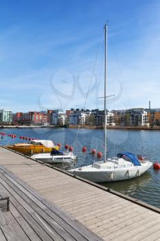 Sailing yachts moored near wooden pier in Stockholm city, Sweden