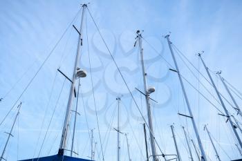 Masts of sailing yachts against the blue sky