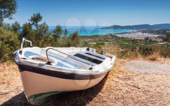 Old white row boat on coast of Zakynthos island, Greece. Summer landscape 