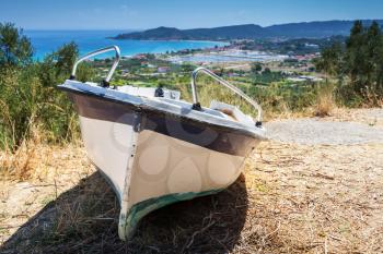 Old small fishing row boat on the coast. Summer landscape of Zakynthos island, Greece